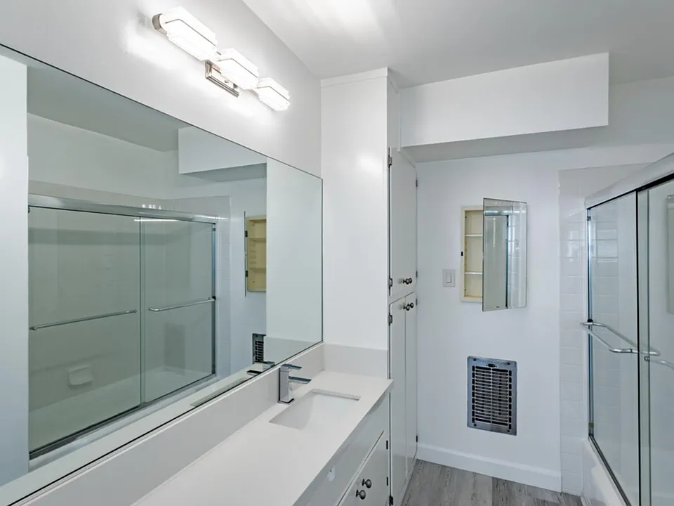 WOW! Check out this bathroom. With heater, cabinet space and bathtub.