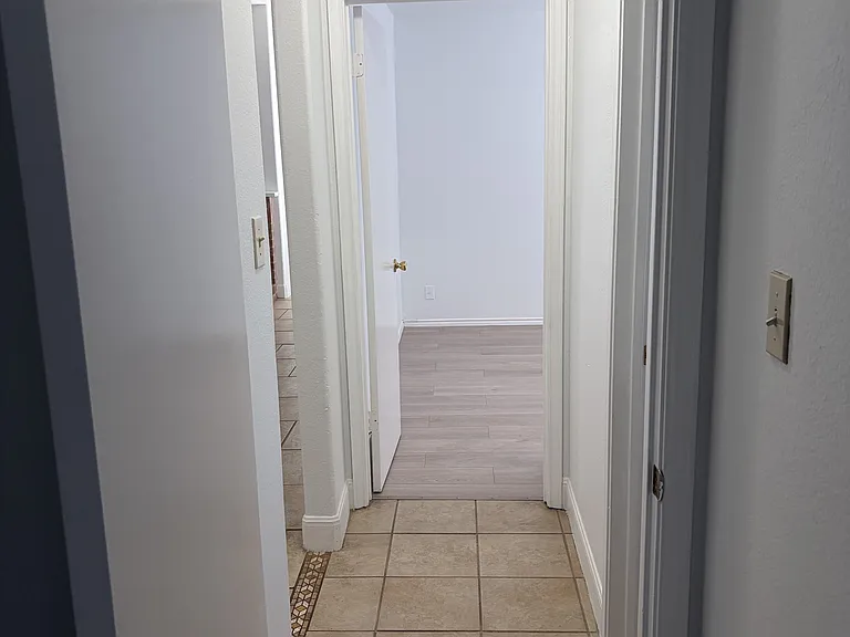 Secondary bedrooms hallway, living area door on left, bathroom door on right, #2 straight ahead