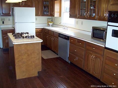 Beautiful 3/4 " solid oak hardwood floors; lots of custom kitchen cabinets. All kitchen appliances remain. Priced to sell, one year home warranty offered with full-price offer.