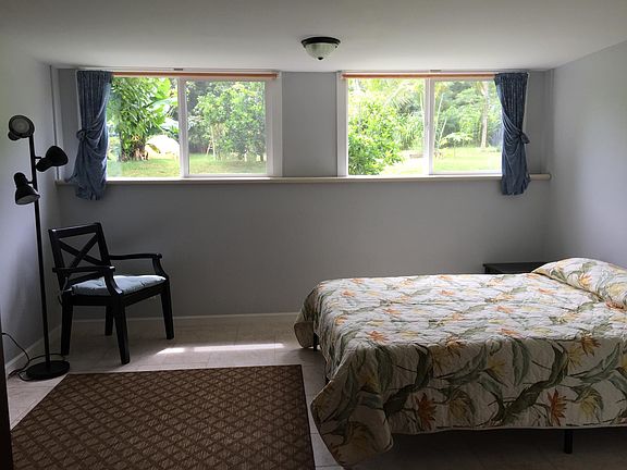 Bedroom with views of back yard and hills