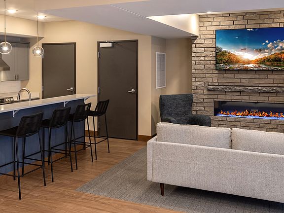 Community Room with full kitchen, TV, game area, and high-end complimentary coffee machine