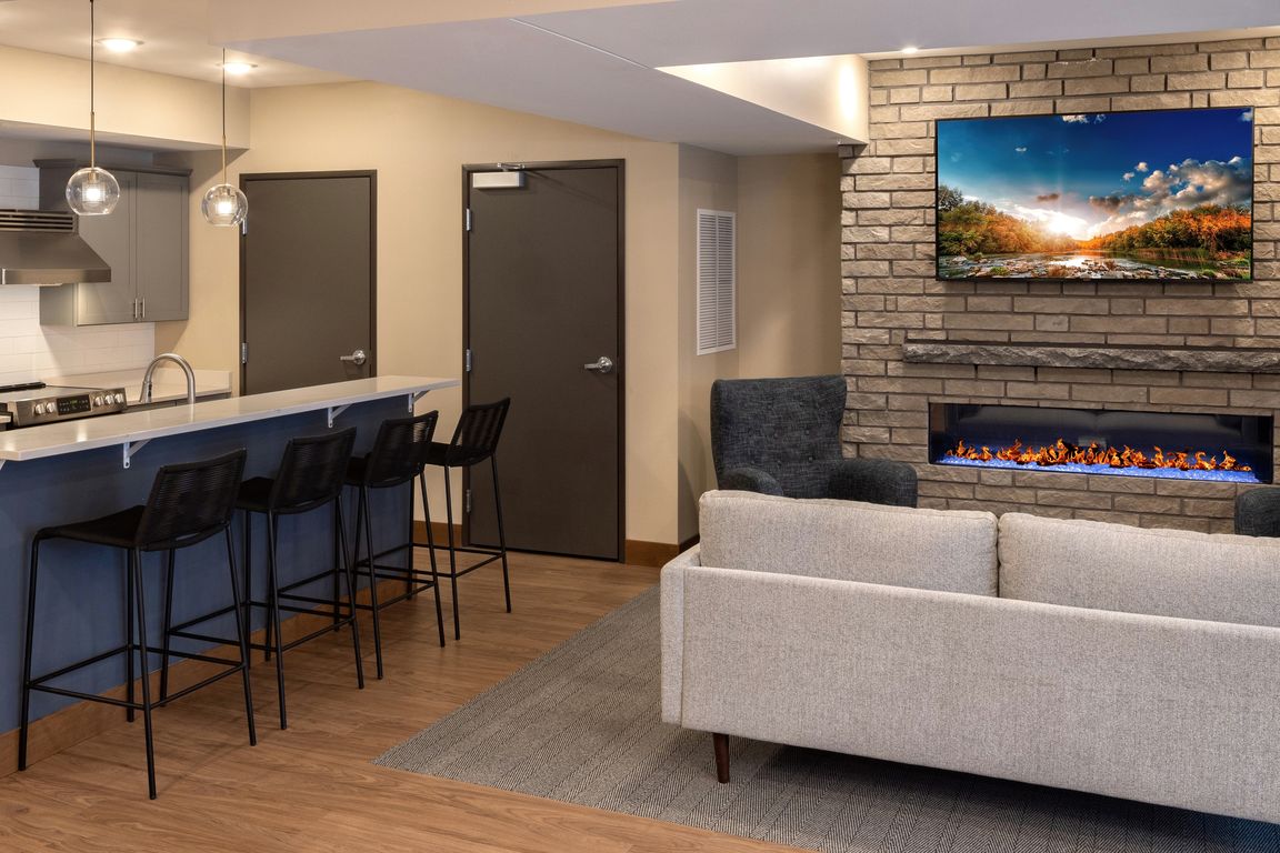 Community Room with full kitchen, TV, game area, and high-end complimentary coffee machine