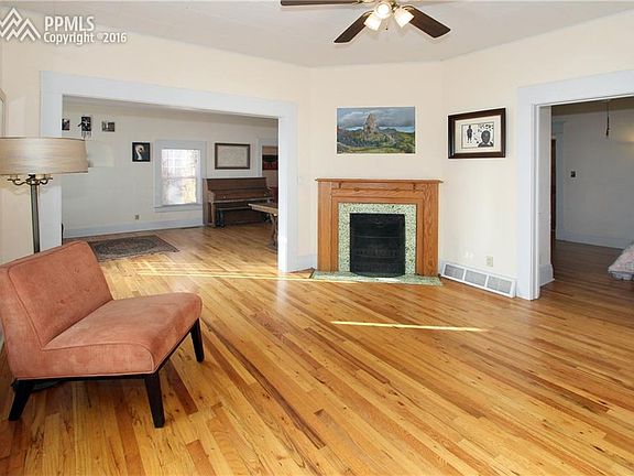 Living room has an original Van Briggle Fireplace.