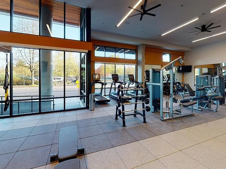Cardio and weight stations in the club-quality fitness center