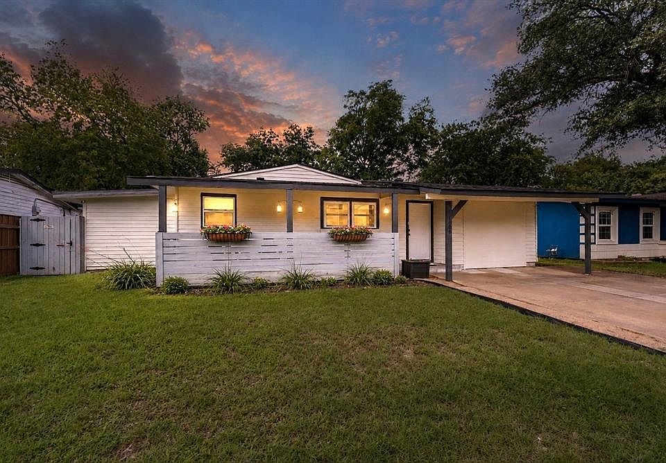 White siding exterior with a dark trim roofline