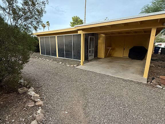 There is an AZ Room on the back of the house that is fully screened, along with a single carport accessed via the alleyway. There is ample parking along the circle driveway as well.