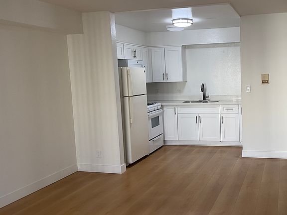 Kitchen area (microwave, gas range/oven, fridge)