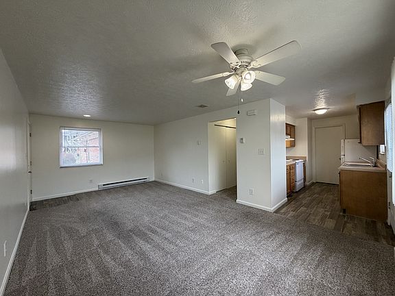 Step into a world of comfort at Broadmoor Apartments. This spacious living area features a modern design, ample natural light, and a seamless flow to the kitchen, perfect for entertaining. Don't miss outschedule your tour today!