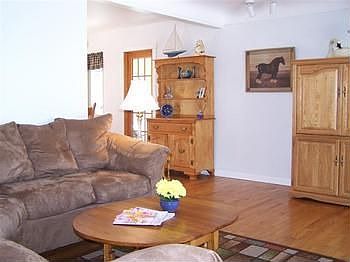 Living Roombr Spacious living area with beautiful hardwood floor and large picture window.