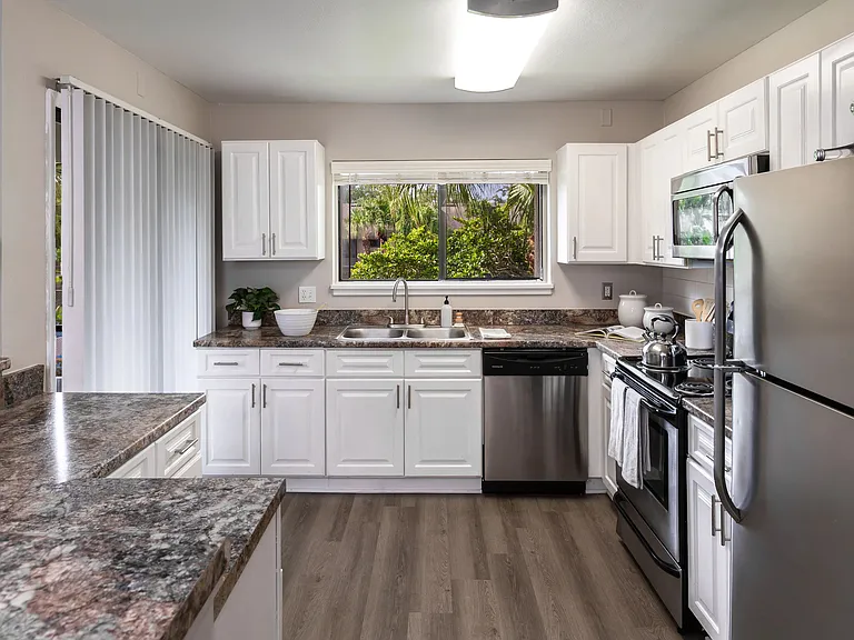 Cook in comfort with a bright window view, generous counter space, and stainless steel appliances.