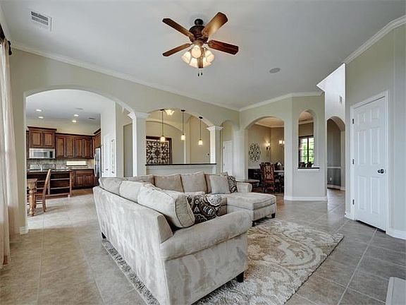Spacious family room opens to the kitchen. Crown molding and architectural arches.