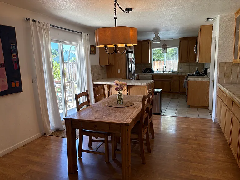 Dining area and kitchen with sliding door to the back yard