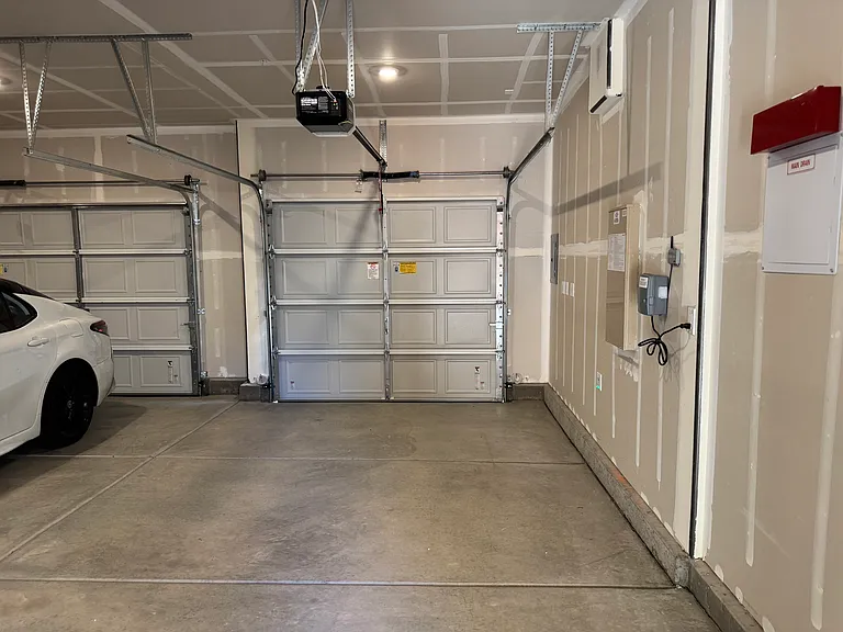 Inside view of garage including 1-car and 2-car bay.