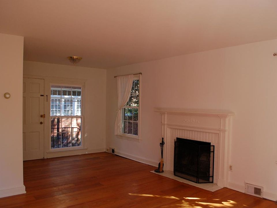living room with wood burning fireplace and hardwood floors