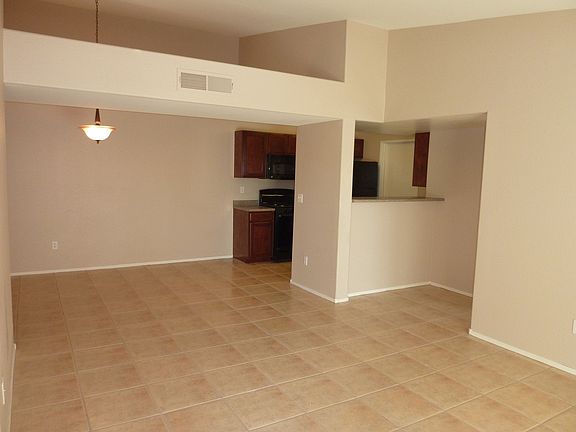Tile dining and kitchen shown. Also vaulted ceiling