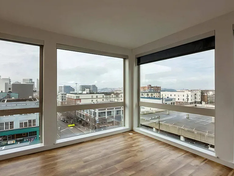 Apartment Living Space with Oversized Windows and Wood Floors