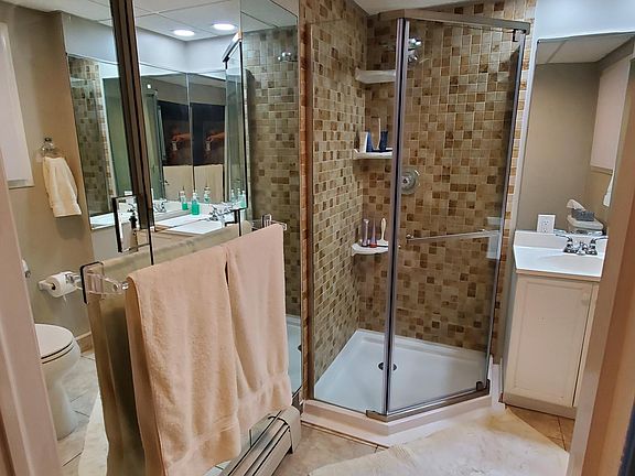New shower stall/tile. New paint in bathroom. Medicine cabinet above towels.