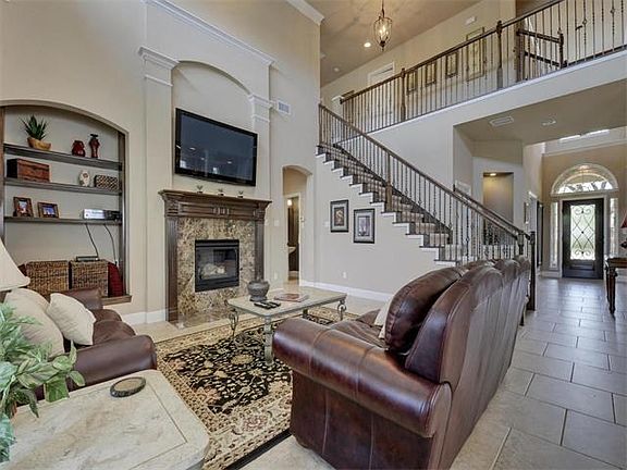 Spacious and light-filled view of downstairs living area and stairs.