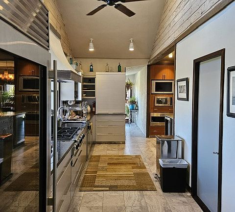 Kitchen and on the right the powder room...Hall to the back door by the TV and microwave