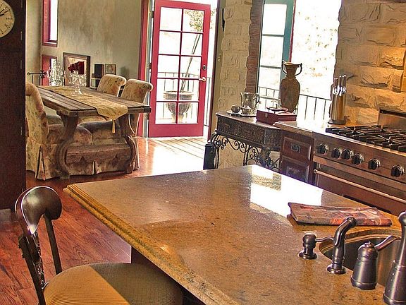 View of Dining room from kitchen with private deck with mountain views