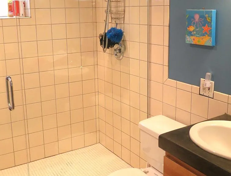 Bathroom 3 has a walk in tile shower with glass door