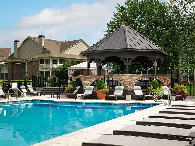 Resort-style pool with lounge seating and gazebo
