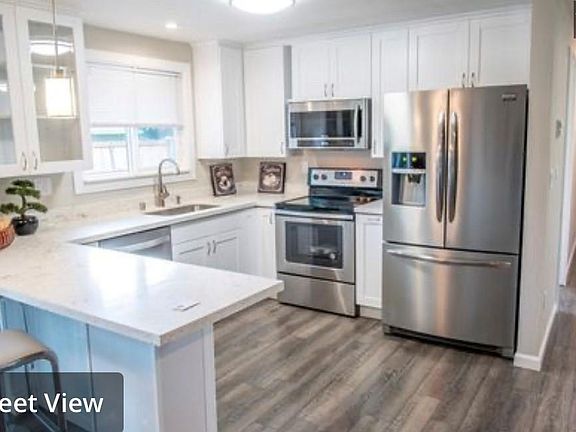 Kitchen with stainless appliances and white cabinets