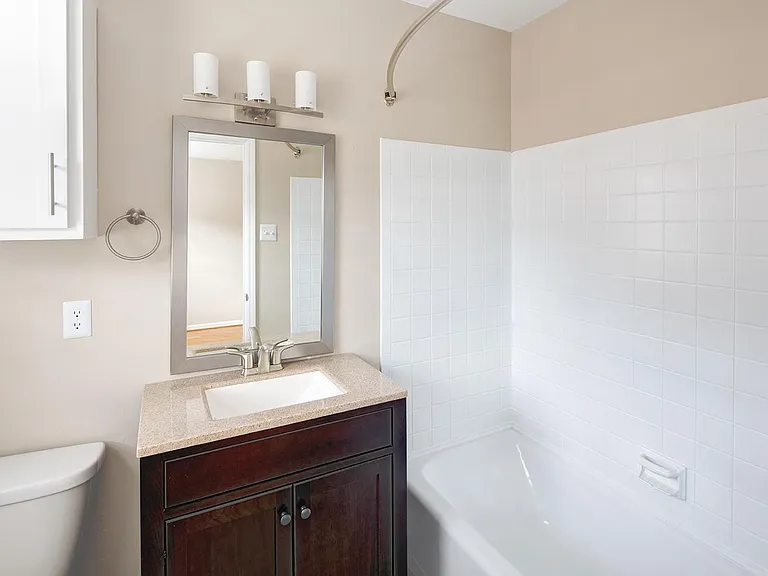 Select Guest Bathrooms With Cherry Vanity Add Warm Tones to the Room