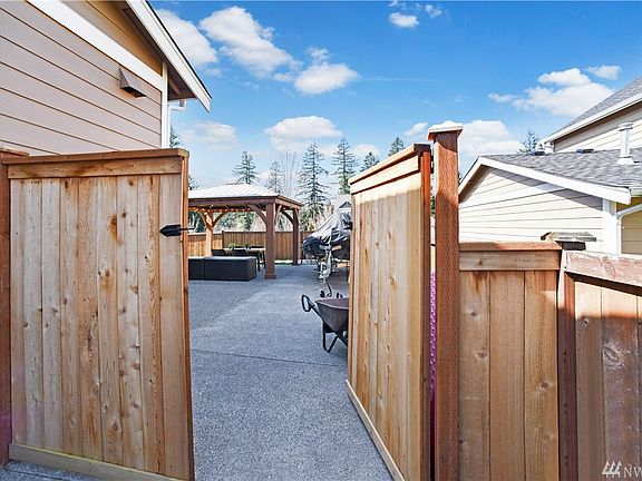 Fully fenced, private backyard with space for entertaining, relaxing, and storing all your toys.