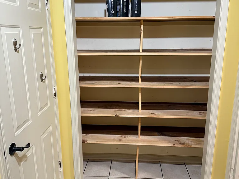 Large shelved pantry area off kitchen in laundry/utility room.