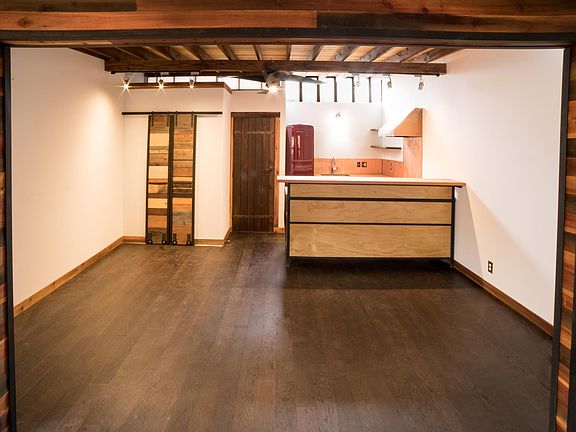 View of main room Mixed wood and wrought iron wall dividing rooms