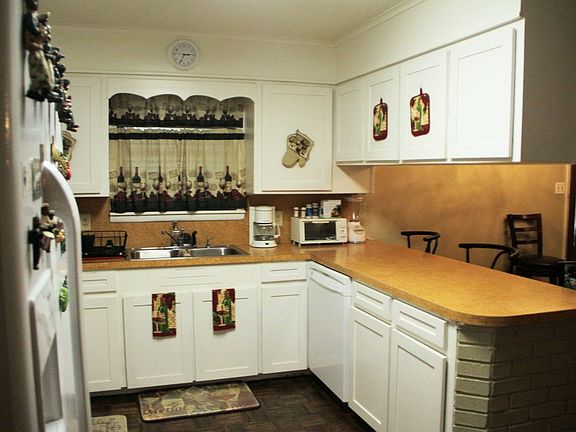 Kitchen is an open room with eat in area and den area.