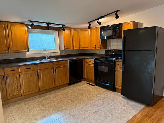 Vaulted Kitchen features track lighting open to space that can be used as Dining or Living- you decide!