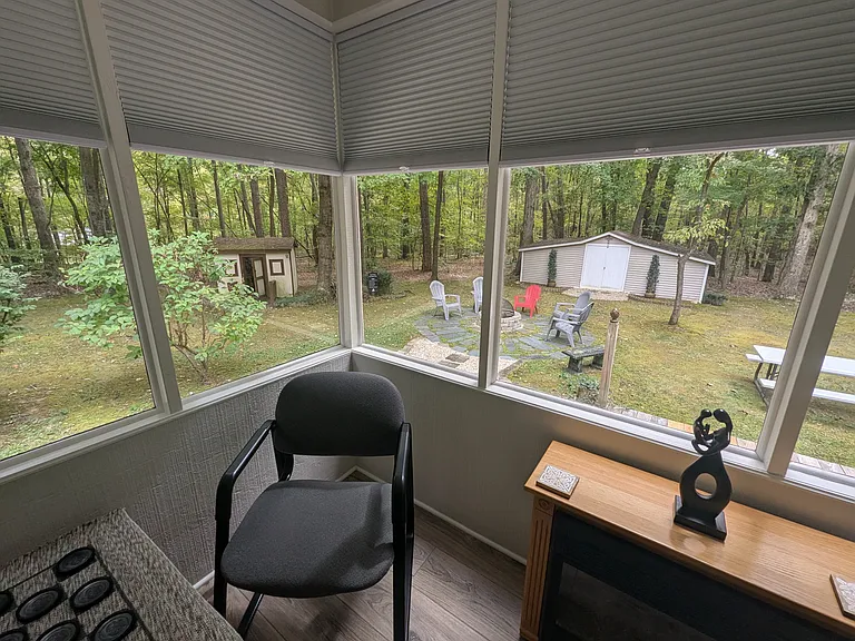 Looking into the back yard and the playhouse from inside the sun-room.