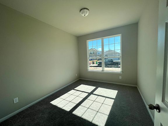Construction progress -secondary bedroom with large windows allowing plenty of sunshine in
