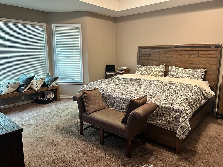 A beautifully high ceiling master bedroom creating a cozy and versatile space!