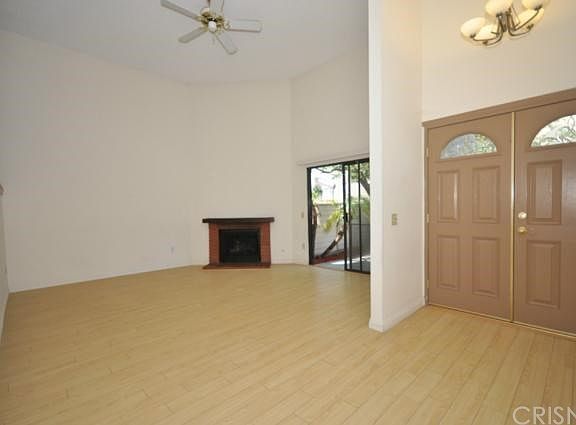 Enter into living room with 2-story ceiling, fireplace and s