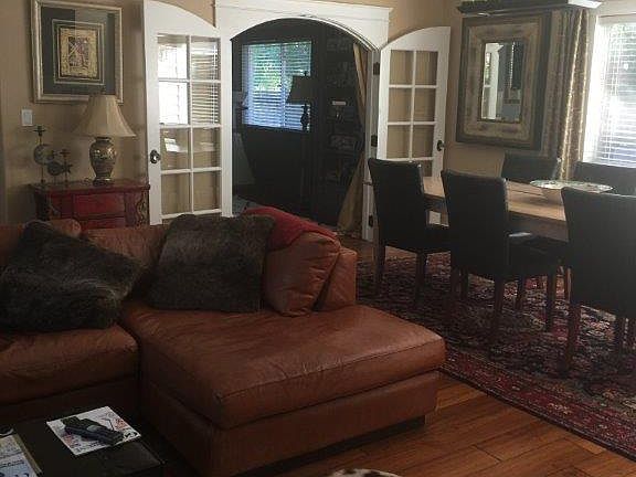 Living/Dining combo. Large custom table, comfy leather couch