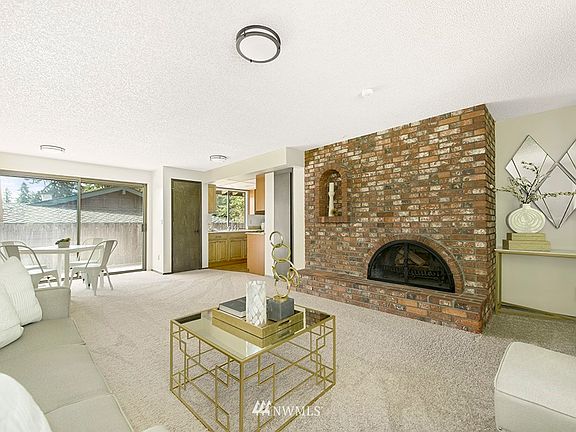 Spacious Family Room with wood-burning fireplace and lots of natural light.