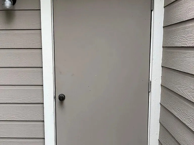 Storage room access located off back patio
