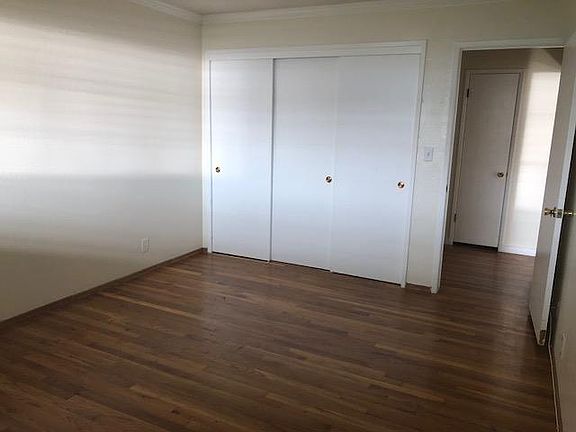 Bedroom with three sliding door closet
