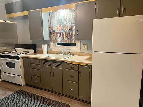Kitchen with gas stove and refrigerator