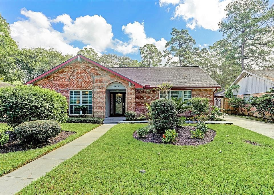 Mature landscaping adorns this beautiful brick one story