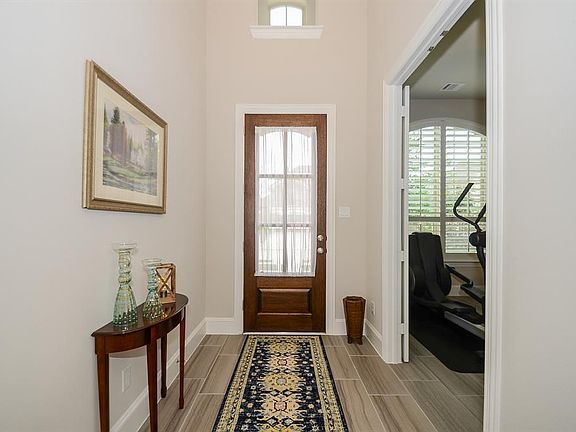 The front entry is light and airy with soaring high ceilings (no sky diving allowed).