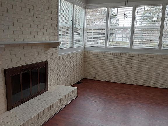 The end of the sunroom is surrounded by a number of windows. There is a fireplace in this area but is not open to the tenant use.
