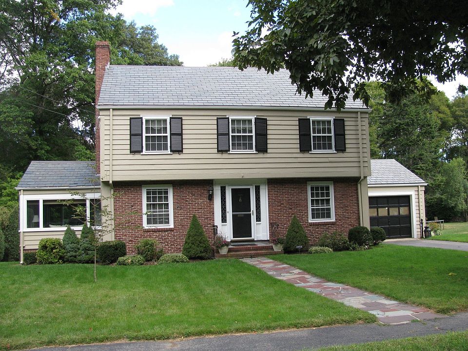 Clapboard and brick exterior, slate roof with copper cap