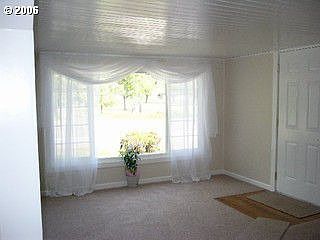 Living Room overlooking Rd and small driveway 