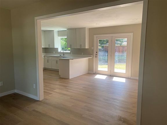 view from living area to open kitchen & 2nd living possibility