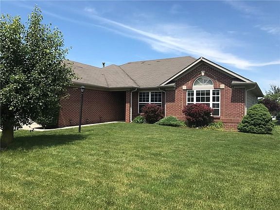 Spacious front yard with beautiful trees.