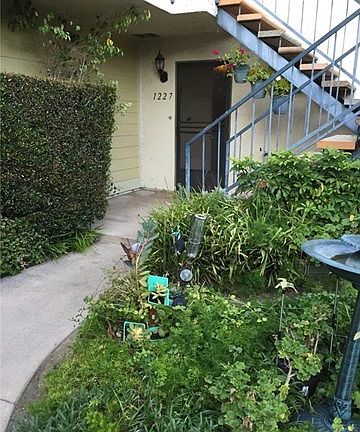 Beautiful landscaping leading to front door of condo